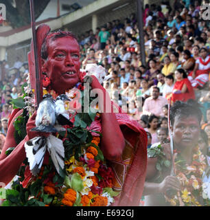 Gauhati, India. 18th Aug, 2014. Hindu priests smeared with sacrificial blood perform rituals during the Deodhani festival at the Kamakhya Hindu temple in Gauhati, India, Aug. 18, 2014. The Deodhani festival is held to worship the serpent goddess Kamakhya. Credit:  Stringer/Xinhua/Alamy Live News Stock Photo