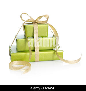 Three gift boxes wrapped in green paper with golden ribbon for Christmas Stock Photo
