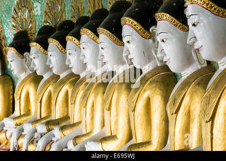 Many seated Buddha sculptures, walls decorated with glass mosaics, Umin Thounzeh, Umin Thonse or U Min Thonze Pagoda or 30 Caves Stock Photo