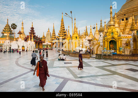 Monks, worshipers and visitors, shrines, stupas, chedis, Shwedagon Pagoda, Singuttara Hill, Yangon, Yangon Region, Myanmar Stock Photo