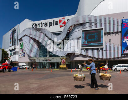 Market vendor carrying a yoke, in front of the Central Plaza Shopping Centre, Udon Thani, Isan, Thailand Stock Photo