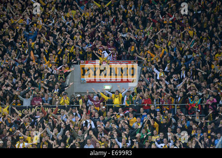 Dresden, Germany. 18th Aug, 2014. Fans of Dresden cheer for their team during the DFB Cup 1st round soccer match between SG Dynamo Dresden and FC Schalke 04 at Gluecksgas Stadium in Dresden, Germany, 18 August 2014. Photo: Thomas Eisenhuth/dpa/Alamy Live News Stock Photo