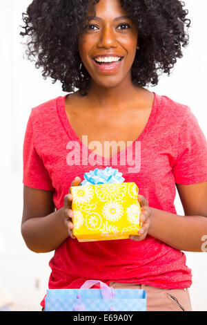 Mixed race woman holding birthday present Stock Photo