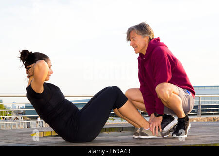 Couple exercising in waterfront park Stock Photo