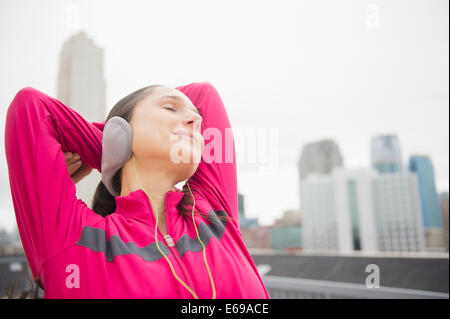 Caucasian woman stretching in city Stock Photo