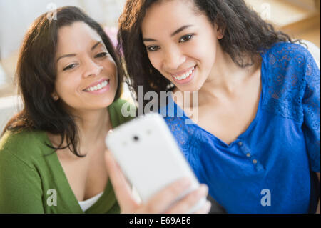 Mother and daughter taking picture with cell phone