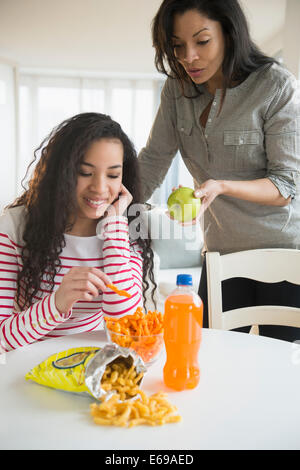 Mother offering daughter healthy snack Stock Photo
