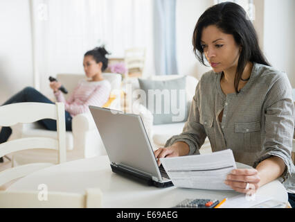 Woman paying bills online Stock Photo