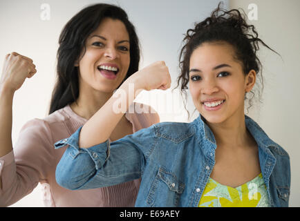 Mother and daughter flexing their muscles Stock Photo