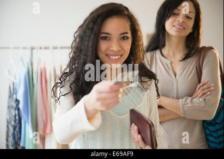 Teenage girl paying with credit card in store
