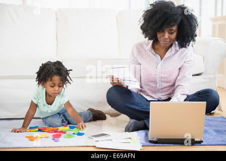 Mother and daughter relaxing in living room Stock Photo
