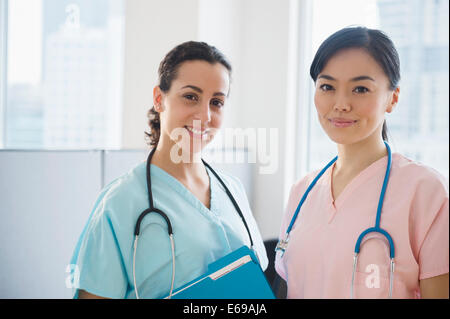Nurses smiling together in hospital Stock Photo