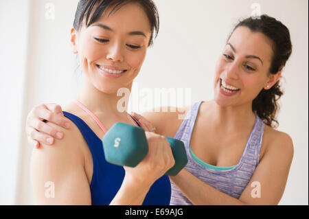 Women exercising together in gym Stock Photo