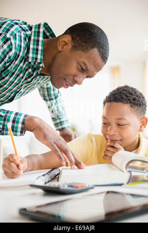 Father helping son with homework Stock Photo