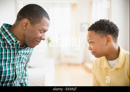Father and son making faces at each other Stock Photo