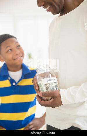 Father and son saving money for college Stock Photo