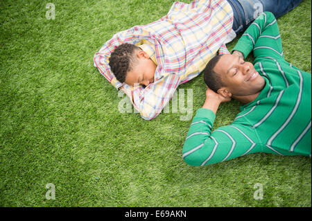 Father and son relaxing in grass