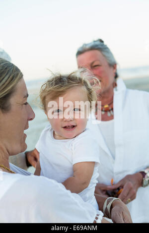Three generations of Caucasian family on beach Stock Photo