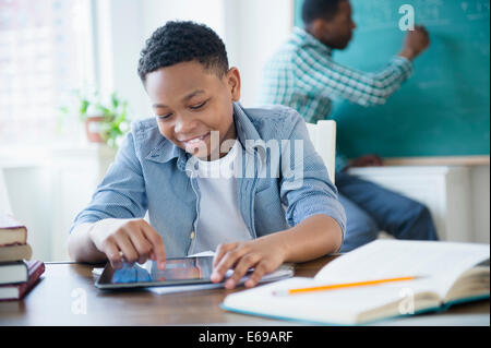 Student using tablet computer in classroom Stock Photo