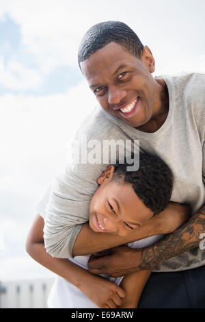 Father and son playing outdoors Stock Photo