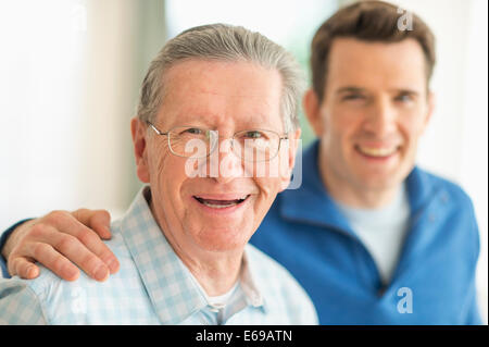 Caucasian father and son smiling Stock Photo