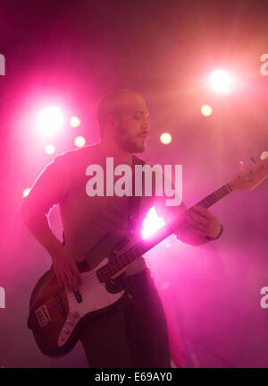 Hispanic musician playing electric guitar on stage Stock Photo