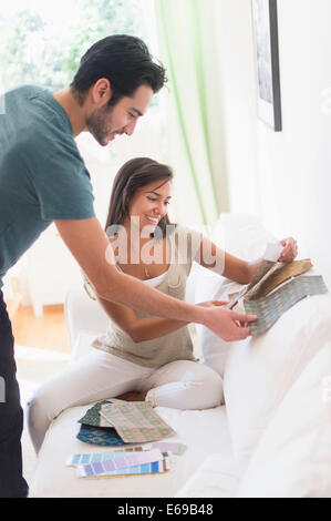 Couple picking out fabric swatches together Stock Photo