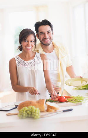 Couple cooking together in kitchen Stock Photo
