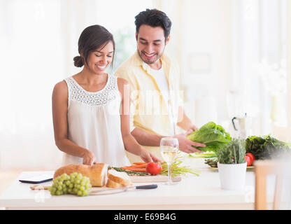 Couple cooking together in kitchen Stock Photo