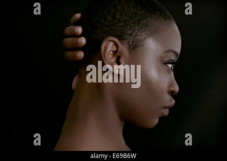 Black woman with hand behind head Stock Photo