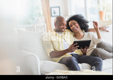 Couple using digital tablet together