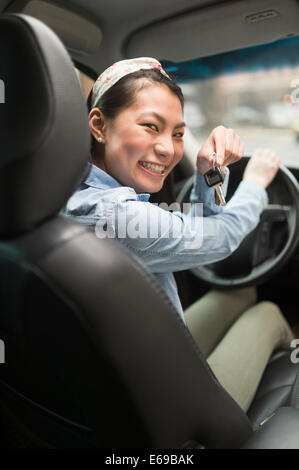 Mixed race teenage girl holding keys to car Stock Photo