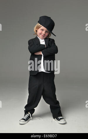 Caucasian boy posing in oversized suit Stock Photo