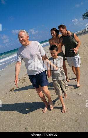 Family walking together on beach Stock Photo