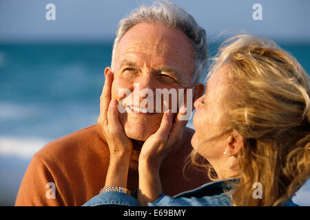 Senior couple relaxing on the beach during summer vacation Stock Photo ...