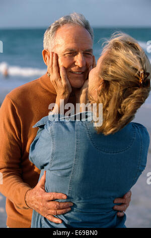 Senior couple hugging on beach Stock Photo