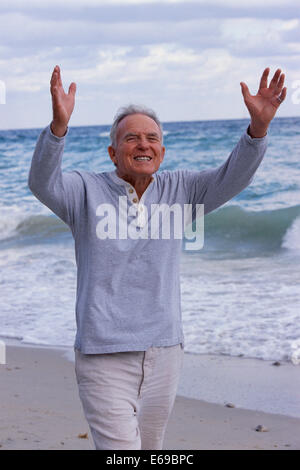 Senior man walking on beach Stock Photo