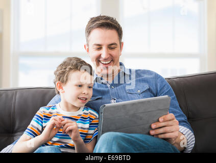Caucasian father and son using tablet computer Stock Photo