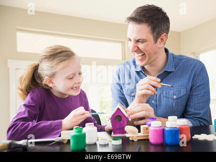 Caucasian father and daughter painting together Stock Photo