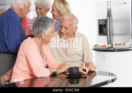Senior couple having coffee in kitchen Stock Photo