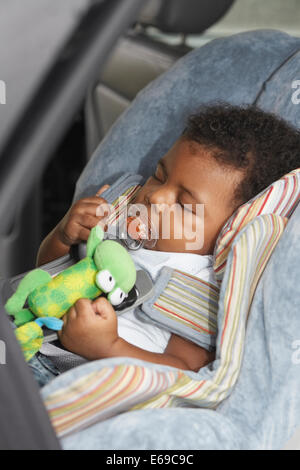 Black baby sleeping in car seat Stock Photo