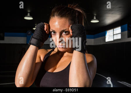 Caucasian fighter training in gym Stock Photo