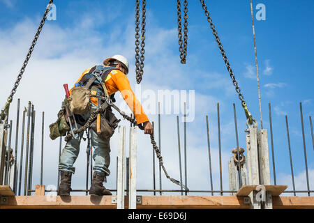 Caucasian worker holding chain at construction site Stock Photo