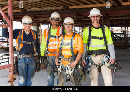 Workers smiling at construction site Stock Photo