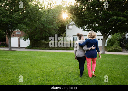 Caucasian mother and daughter walking in park Stock Photo