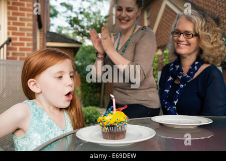Three generations of Caucasian women celebrating birthday Stock Photo