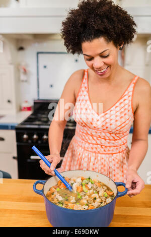 African American woman cooking in kitchen