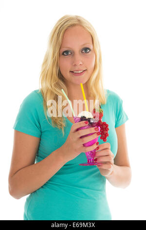 Blond woman eating ice cream with fresh fruit isolated over white background Stock Photo