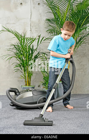 6 years old boy cleaning floor by vacuum cleaner Stock Photo - Alamy