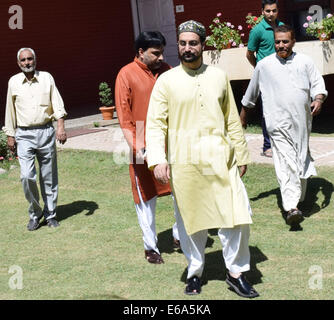 Srinagar, Indian Administered Kashmir. 19th Aug, 2014. Chairman of All Parties Hurriyat Conference (APHC),  Kashmiri separatists, Mirwaiz Umar Farooq, along with his party workers arrives to address the media before leaving to New Delhi for a meeting with Pakistani high commissioner in Srinagar In a blow to efforts to improve often-hostile ties, India on Monday called off talks with Pakistan over a meeting between its ambassador and Kashmiri separatists. Credit:  Sofi Suhail/Alamy Live News Stock Photo